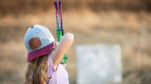 Girl shooting bow in backyard f4159788da6a13a05c7755e7e3b29890