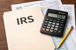 Web Tax preparation tools on wooden desk e991f65cda8cad0d03a7ea8cd2674507